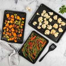 Black nonstick sheet pan set with textured cooking surfaces for roasting