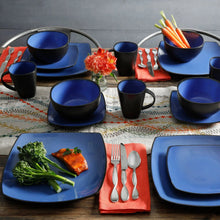 Blue and dark mugs, bowls, and square plates in a table setting