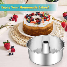 Stainless steel tube cake pan with topped cake and berries on a serving plate