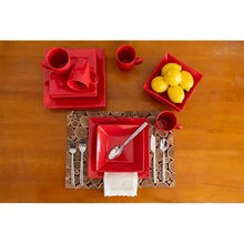 Red stoneware place setting with square plates, cups, and serving bowl plus lemons