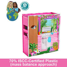 Pink doll house playset with open kitchen area and garden-themed side decor