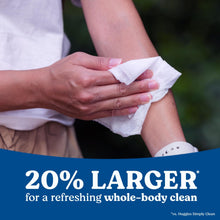 Huggies XL unscented wipes in hands cleaning an arm