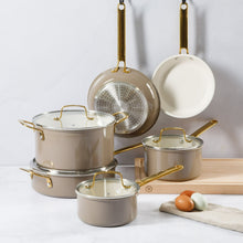 Nonstick pots and pans set with stainless sides, taupe exterior, gold handles