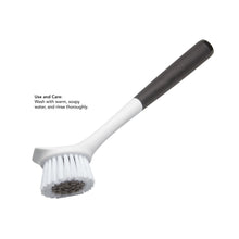Sink brush with white bristles, dark scrubbing tip, and black soft-touch handle