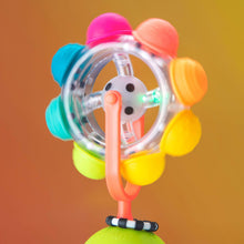 Light-up spinning suction cup baby tray toy with clear rainbow reel and colored knobs