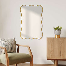 Large wavy-edge wall mirror with gold frame, vertical orientation