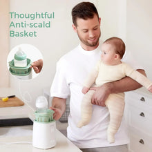 Baby bottle warmer with anti-scald basket, shown being used