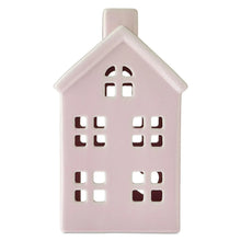 Pink ceramic house decoration with multiple cutout window shapes, front view