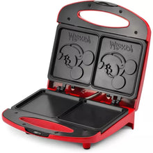 Red dual sandwich maker opened, showing two black grilling plates