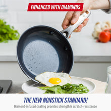 Ceramic nonstick frying pan, dark blue, with metal utensil inside for cooking