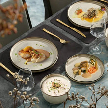 Cream ceramic plates and bowls with gold rim, reactive-glaze dinnerware