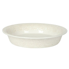 Cream stoneware pie pan with embossed lace design on rim and base, shallow tart dish