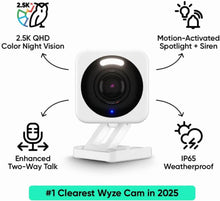 Wyze Cam V4 security camera on white tabletop stand with visible lens