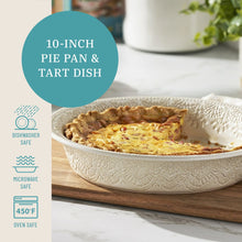 Cream stoneware pie pan holding baked tart with lace-embossed edges