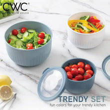 Blue-gray ribbed mixing bowl set with lids, filled with fresh vegetables