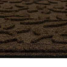 Brown leaf-vine doormat surface close-up, detailed textured leaf pattern