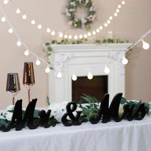 LED globe string lights with glowing white globe bulbs along the strand