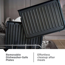 Removable grilling plate lifted from grill, shown over dishwasher rack