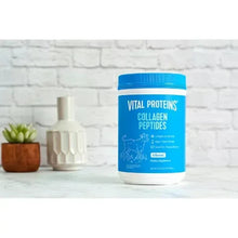 Vital Proteins collagen peptides powder tub with blue cap on kitchen counter