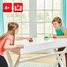 Hover shell strike tabletop game set, red shell being pushed on a table by kids