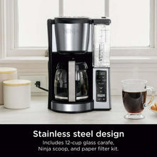 Black and stainless steel coffee maker with glass carafe and removable water reservoir