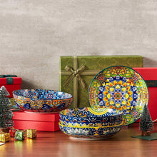Stacked colorful ceramic pasta bowls with blue, yellow, and floral patterns
