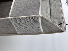 Gray organizer bottom panel with mesh pocket and stitched trim