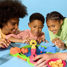 Hungry Hungry Hippos game set on green base with colorful hippos and pink bowl of chips