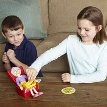 Kids playing Greedy Granny game toy with red chair and character pieces on table