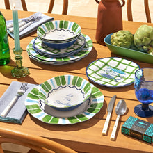 Assorted melamine bowls and plates with green stripe pattern, stacked set