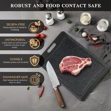 Dark grey plastic cutting boards with juice groove and handle, shown with knife.