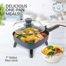 Gray electric skillet with glass lid and food, showing compact one-pan meal setup