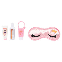 Pink satin sleep mask accessory with black eyelashes and small crown emblem
