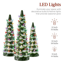 Three green ceramic tabletop Christmas trees with multicolor LED bulbs