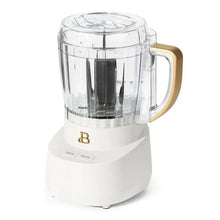 Drew Barrymore 3-cup food chopper, clear bowl on white base with gold handle
