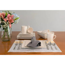 Cream-white stoneware place settings with square plates, bowls, and coffee mugs