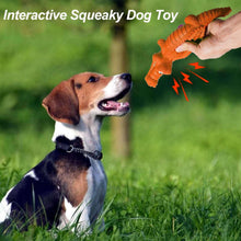 Orange crocodile squeaky chew toy with ridged body, held in a hand.