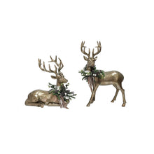 Set of 2 holiday deer ornaments: one standing and one lying, with pine greenery