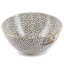 Large ceramic bowl with black speckle dot pattern and gold rim, label on side