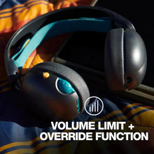 Black over-ear headphones with teal controls and padded ear cushions