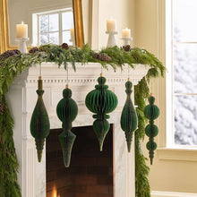 Member's Mark set of five green oversized honeycomb paper ornaments hanging on a mantel