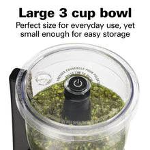Clear 3-cup chopper bowl with black lid cap, filled with green puree