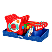Red toy guitar with colored keys and arched speaker panel, boxed with insert