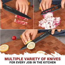 Kitchen knives with black speckled blades cutting onions, bread, and citrus on a board