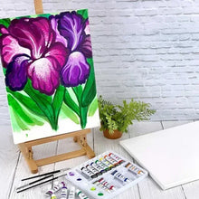 Painted stretched canvas artwork on an easel, colorful flower design on white