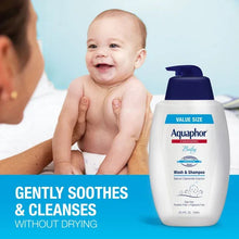 Aquaphor Baby wash & shampoo bottle beside a smiling baby
