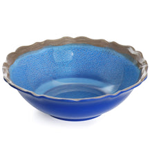 Blue melamine bowl with scalloped edge and textured surface.