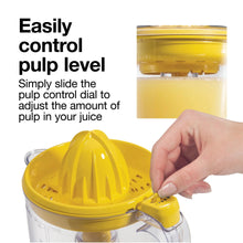 Electric citrus juicer with yellow pulp control dial on clear pitcher