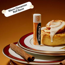 ChapStick warm cinnamon roll lip balm stick with frosting-topped roll on plate