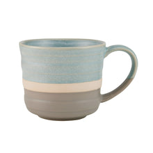 Blue stoneware coffee mug with speckled glaze and curved handle.